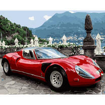 Красный спорткар в горах у моря