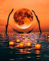 Гамак в море под красной луной