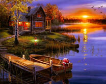 Уходящее солнце над рекой у домика