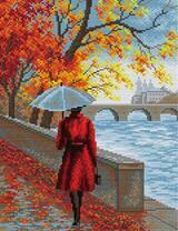 Девушка в красном пальто под зонтом на набережной