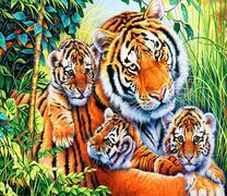 Тигрица с тремя тигрятами в летней траве