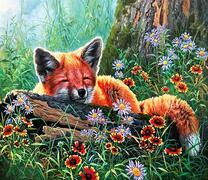 Лисенок спит под деревом в цветах