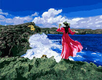 Девушка в летнем платье на прибрежных камнях