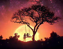 Дети на качеле под деревом