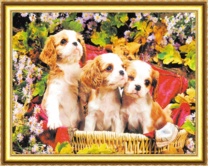 Три щеночка в корзине среди цветов