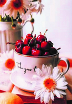 Чашка красной вишни и букет ромашек