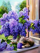 Котёнок в склубком под букетом сирени