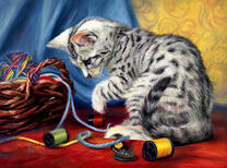 Котенок играет нитками