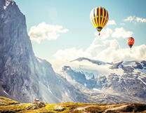 Два воздушных шара над снежными вершинами гор