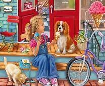 Девочка кормит щенка и котенка мороженым