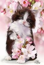 Пушистый котёнок среди цветущих ветвей